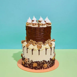 2 Tier Cake - Design Your Own with chocolate and vanilla layers, cream frosting, and decorative toppings by Crumbs & Doilies.